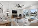 Bright living room featuring a plush sofa, modern furniture, and sliding glass doors with view of a pool area at 1424 47Th Ne Ave, St Petersburg, FL 33703