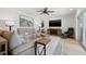 Comfortable living room featuring stylish decor, a plush sofa, modern furniture, and a large television at 1424 47Th Ne Ave, St Petersburg, FL 33703