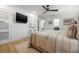 Bright main bedroom with hardwood floors, TV, and private bathroom at 1424 47Th Ne Ave, St Petersburg, FL 33703