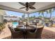 Covered patio with dining table, fan, pool, and waterfront views create the perfect outdoor experience at 1424 47Th Ne Ave, St Petersburg, FL 33703