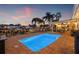 Outdoor pool area with waterfront views, outdoor furniture, and lighting for evening enjoyment at 1424 47Th Ne Ave, St Petersburg, FL 33703