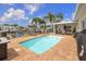 A tranquil pool area with brick pavers, comfortable seating, and serene waterfront views at 1424 47Th Ne Ave, St Petersburg, FL 33703