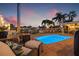 Beautiful pool with waterfront views, outdoor furniture, and cozy lighting for evening enjoyment at 1424 47Th Ne Ave, St Petersburg, FL 33703