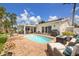 Backyard oasis featuring a sparkling pool, brick patio, outdoor seating, and lush landscaping creating a perfect relaxation space at 1424 47Th Ne Ave, St Petersburg, FL 33703