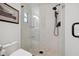 Beautifully tiled shower with glass enclosure, rainfall showerhead, and mosaic stone flooring at 1424 47Th Ne Ave, St Petersburg, FL 33703