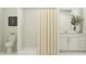 Clean bathroom with a tiled shower, vanity with storage, and neutral color palette at 14958 Topaz Blue St, Wimauma, FL 33598