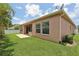 Lush backyard featuring a well-maintained lawn, inviting patio, and clean architectural lines at 1902 Marshberry Ct, New Port Richey, FL 34655