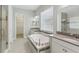 Bright bathroom with a soaking tub, double vanity sinks, and a glass-enclosed shower at 1902 Marshberry Ct, New Port Richey, FL 34655