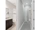 Hallway view to bathroom featuring granite countertop, tub and tiled floor at 1902 Marshberry Ct, New Port Richey, FL 34655