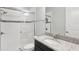 Modern bathroom with a glass-enclosed shower, sleek fixtures, and granite countertop vanity at 1902 Marshberry Ct, New Port Richey, FL 34655