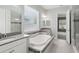 Bright bathroom with a soaking tub, double vanity sinks, and a glass-enclosed shower at 1902 Marshberry Ct, New Port Richey, FL 34655