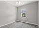 Neutral bedroom with carpeted floors, a window providing natural light, and neutral paint at 1902 Marshberry Ct, New Port Richey, FL 34655