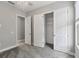 Neutral bedroom featuring carpeted floors, modern lighting, multiple closet options, and natural light at 1902 Marshberry Ct, New Port Richey, FL 34655