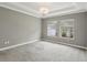 Spacious bedroom with soft carpeting and bright windows with privacy blinds at 1902 Marshberry Ct, New Port Richey, FL 34655