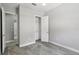 Neutral bedroom with carpeted floors, a walk-in closet, and natural light from windows at 1902 Marshberry Ct, New Port Richey, FL 34655