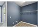 Interior view of bedroom walk-in closet with wall-mounted storage and plush carpeting at 1902 Marshberry Ct, New Port Richey, FL 34655