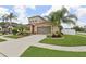Beautiful two-story home boasts a three-car garage and lush landscaping, offering curb appeal at 1902 Marshberry Ct, New Port Richey, FL 34655