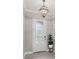 Elegant front entryway featuring a decorative glass door, tiled floor, and stylish light fixture at 1902 Marshberry Ct, New Port Richey, FL 34655