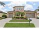 Charming two-story home featuring a three-car garage and a well-manicured lawn with mature landscaping at 1902 Marshberry Ct, New Port Richey, FL 34655
