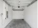Spacious two-car garage featuring overhead lighting and a freshly painted interior at 1902 Marshberry Ct, New Port Richey, FL 34655