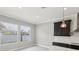 Bright kitchen area featuring a large island, modern fixtures, stainless steel appliances, and ample counter space at 1902 Marshberry Ct, New Port Richey, FL 34655