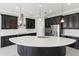 Kitchen featuring a large island with sink, stainless steel appliances, modern lighting, and dark wood cabinets at 1902 Marshberry Ct, New Port Richey, FL 34655