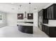 Spacious kitchen with a large island, stainless steel appliances, modern lighting, and dark wood cabinets at 1902 Marshberry Ct, New Port Richey, FL 34655