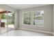 Bright living room featuring tile floors, sliding glass doors to outdoor patio, and natural light from surrounding windows at 1902 Marshberry Ct, New Port Richey, FL 34655