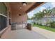 Outdoor kitchen area featuring a built-in grill, refrigerator, and bar seating at 1902 Marshberry Ct, New Port Richey, FL 34655