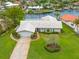 Aerial view of property showing mature landscaping, 2-car garage, and white tile roof at 1917 Iowa Ne Ave, St Petersburg, FL 33703