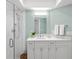 Bathroom with a glass shower, marble vanity, white cabinets, and updated fixtures at 1917 Iowa Ne Ave, St Petersburg, FL 33703