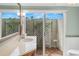 Bright bathroom featuring a marble vanity and sliding glass doors to a private courtyard at 1917 Iowa Ne Ave, St Petersburg, FL 33703