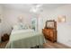 Cozy bedroom with hardwood floors, dresser with mirror, and bright, natural light at 1917 Iowa Ne Ave, St Petersburg, FL 33703