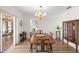 Elegant dining room with a chandelier, wood table, and views of the outdoor seating area at 1917 Iowa Ne Ave, St Petersburg, FL 33703