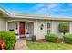 Inviting front entrance featuring a red door, well-maintained landscaping, and a paved walkway at 1917 Iowa Ne Ave, St Petersburg, FL 33703