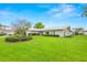 Charming single-story home boasts a lush green lawn, manicured bushes and vibrant landscaping at 1917 Iowa Ne Ave, St Petersburg, FL 33703