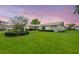 Attractive house with a beautiful green lawn, mature tree, and manicured bushes at 1917 Iowa Ne Ave, St Petersburg, FL 33703