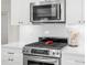 Modern kitchen features stainless steel appliances, gas cooktop, white subway tile backsplash and quartz counters at 1917 Iowa Ne Ave, St Petersburg, FL 33703