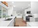 Spacious and well-lit kitchen features quartz countertops, stainless appliances and wooden floors at 1917 Iowa Ne Ave, St Petersburg, FL 33703