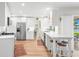 Modern kitchen with stainless steel appliances, white cabinetry and an island with barstool seating at 1917 Iowa Ne Ave, St Petersburg, FL 33703