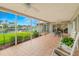 Waterfront views from a covered lanai featuring rocking chairs, outdoor dining, and water views at 1917 Iowa Ne Ave, St Petersburg, FL 33703