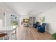 Bright living room features wood floors, ceiling fan, slider to the backyard and a large entertainment center at 1917 Iowa Ne Ave, St Petersburg, FL 33703