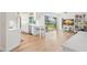 Bright, open-concept living room featuring wood floors, barstool seating and sliding doors to the outside at 1917 Iowa Ne Ave, St Petersburg, FL 33703
