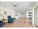 Open-concept living space features wood floors, a ceiling fan, and white cabinetry at 1917 Iowa Ne Ave, St Petersburg, FL 33703