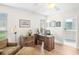 Bright home office with wood floors, modern desk, and chair, adjacent to the main bathroom at 1917 Iowa Ne Ave, St Petersburg, FL 33703