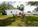 Spacious backyard with a fire pit, outdoor seating, and a patio area with a grill at 2010 6Th Sw Ave, Largo, FL 33770