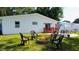 Backyard featuring a fire pit, patio area, and a grill, perfect for outdoor entertaining at 2010 6Th Sw Ave, Largo, FL 33770