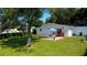 Backyard with a covered patio set, firepit, and a large lawn for relaxing and entertaining at 2010 6Th Sw Ave, Largo, FL 33770