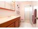 Bathroom featuring cherry wood vanity, tile flooring and a step-in shower at 2010 6Th Sw Ave, Largo, FL 33770