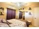 Spacious bedroom with a light ceiling fan, an accent wall, and soft lighting at 2010 6Th Sw Ave, Largo, FL 33770